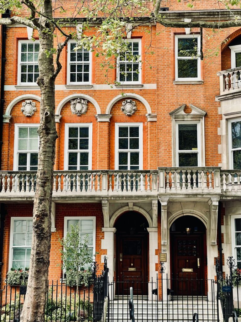 Elegant red brick building featuring classic arched windows and ornate details.